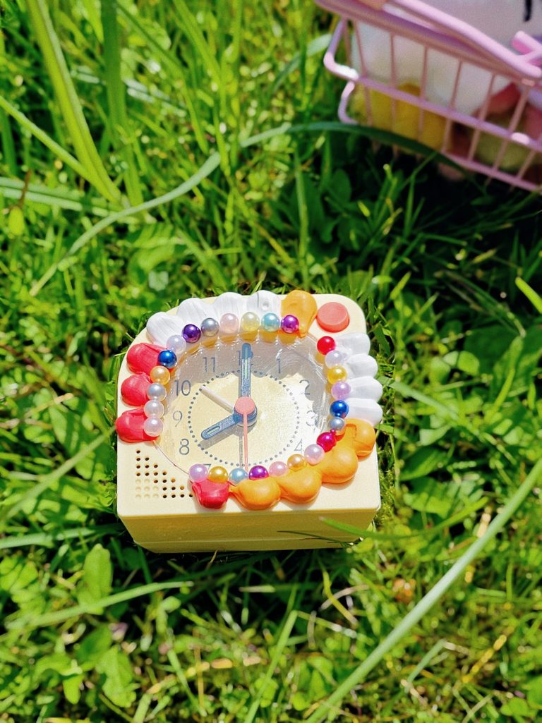 a yellow clock decorated with Japanese art style